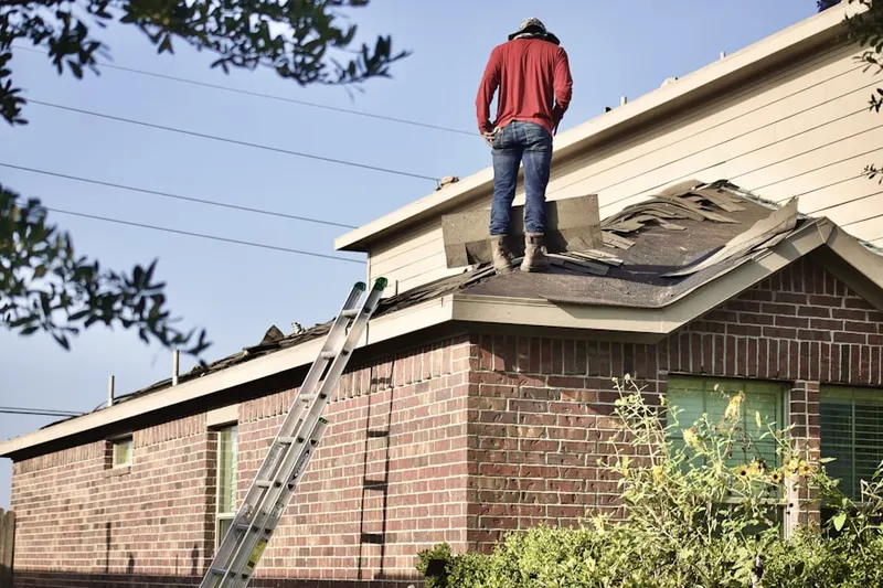 Professional roofer working on a residential roof in Bentley Village-Waterchase